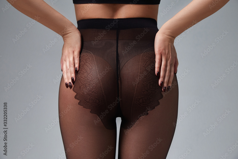Part of woman body perfect shape hips legs skin tan wear stockings, nylons,  pantyhose lingerie hosiery hose studio shot on white background. Stock  Photo