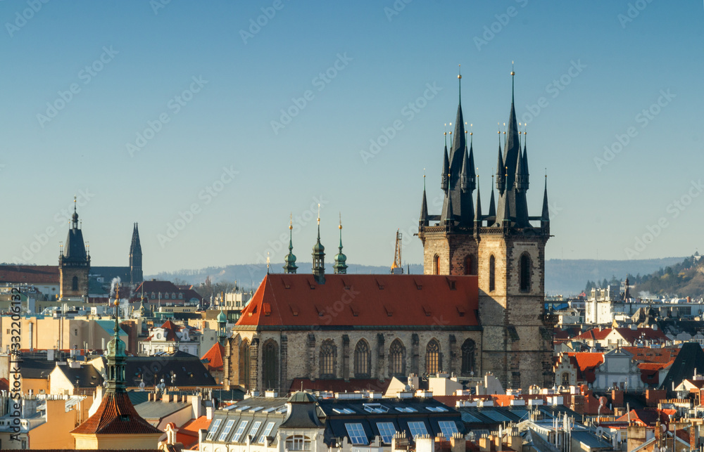 Naklejka premium Overall view of Old Town of Prague shortly after sunrise, sunny spring day with blue sky. The rooftop and towers of Church of Our Lady before Tyn in middle.