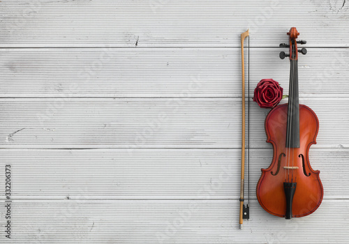 vintage violin on a white wooden background © serikbaib