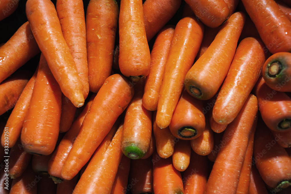 Plenty of fresh orange carrot on a counter in a market Plenty of fresh orange carrot on a counter in a market