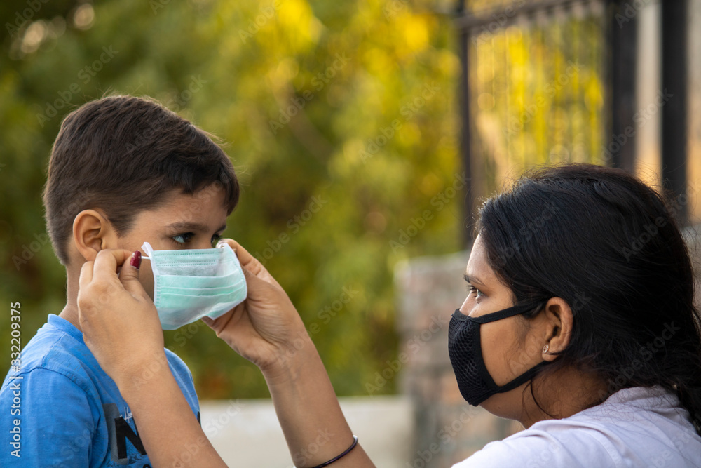 Indian child coughing on his elbow showing tips to protecting corona virus Indian child coughing on his elbow showing tips to protecting corona virus