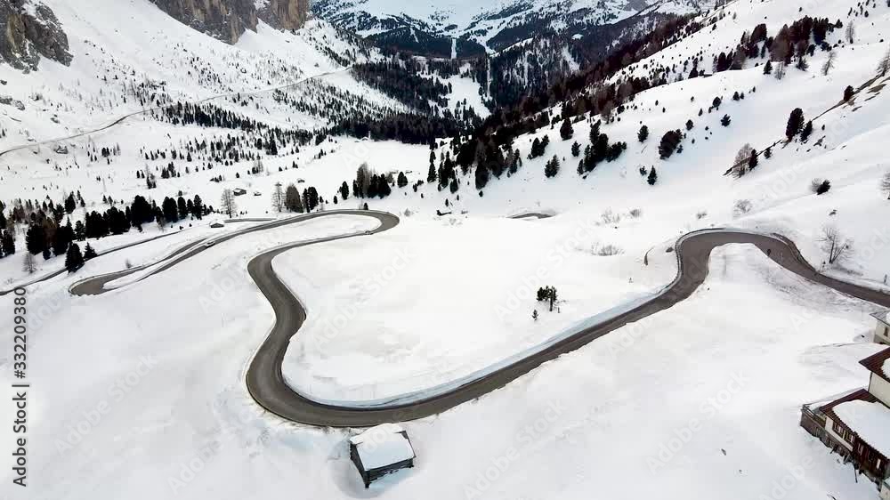 Snowy mountain of the Dolomite above a winding road Snowy mountain of the Dolomite above a winding road
