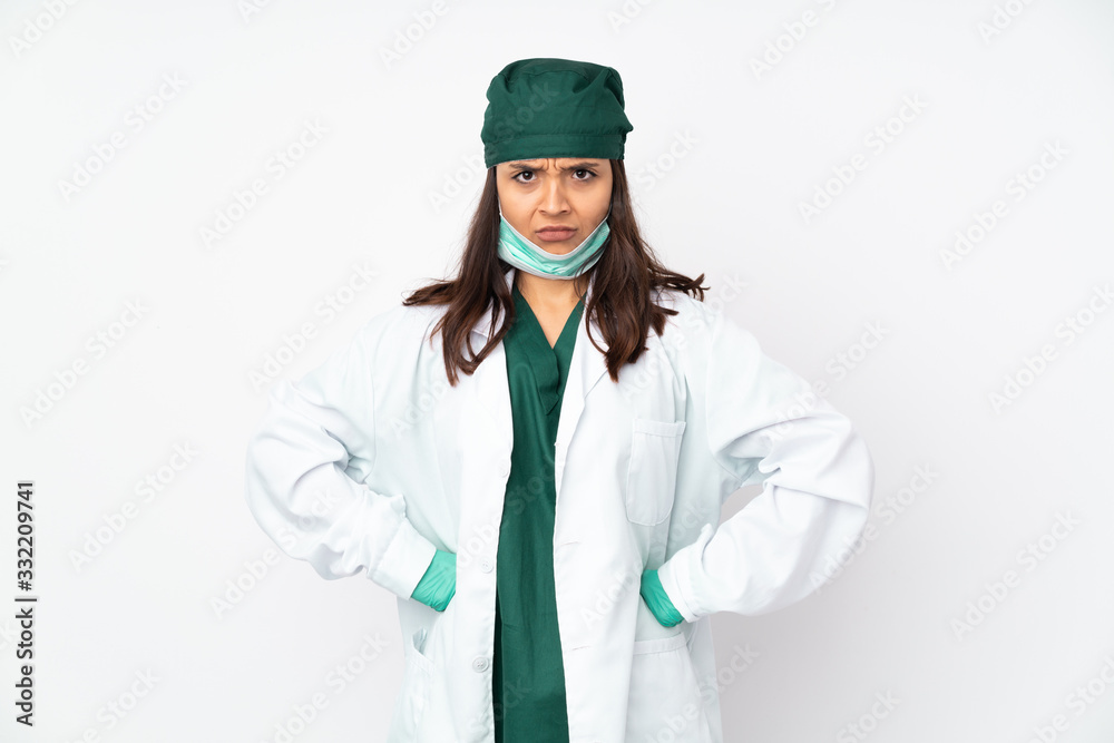 Surgeon woman in green uniform isolated on white background angry Surgeon woman in green uniform isolated on white background angry