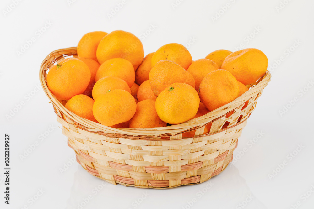 wicker basket with some tangerines isolated on white background wicker basket with some tangerines isolated on white background