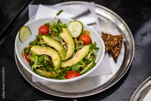 Avocado salad in plate over the table