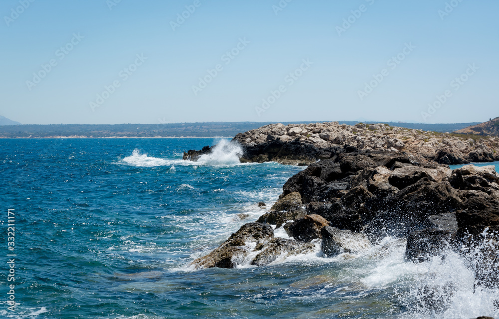Coastline with waves clatters against rocks blue sea greece Kos