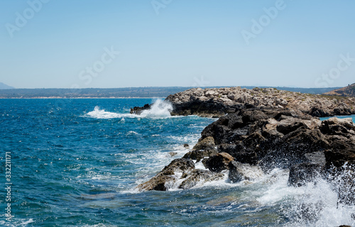 Fototapeta Naklejka Na Ścianę i Meble -  Coastline with waves clatters against rocks blue sea greece Kos