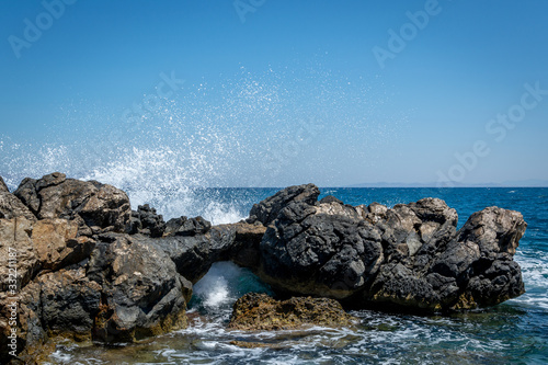 Fototapeta Naklejka Na Ścianę i Meble -  wave clatters against rocks in the sea coast Greece Kos