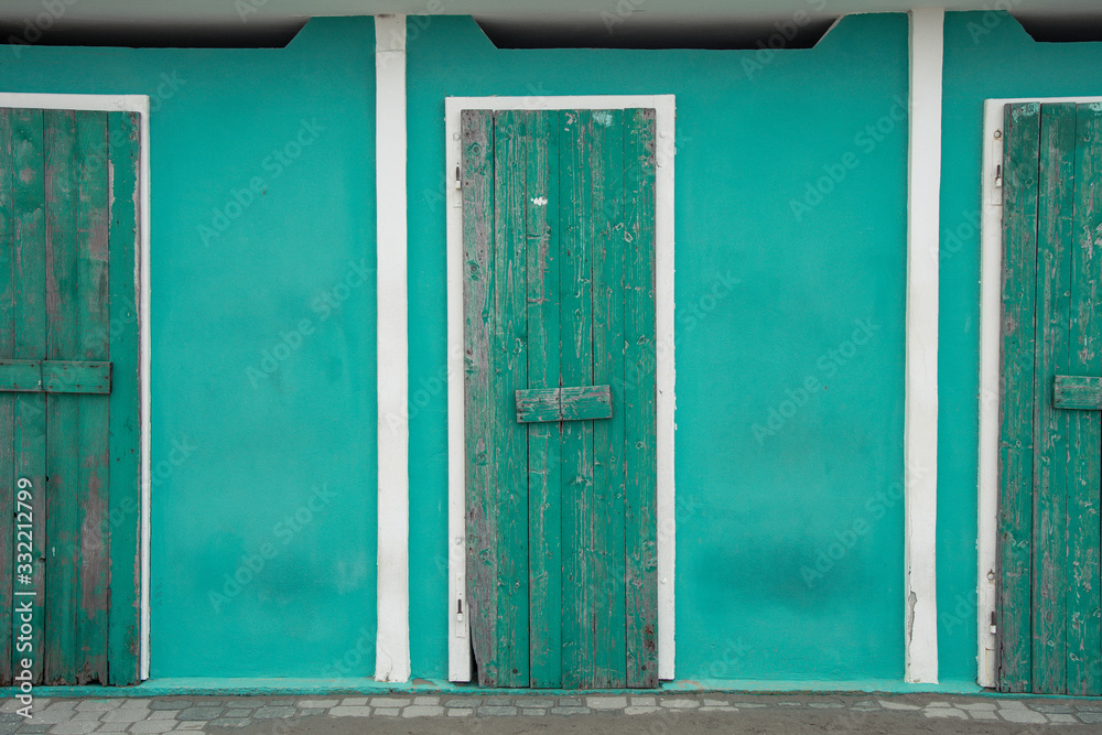 Winter sea mood in the Riviera Romagnola region of Italy. Closed beach cabins painted with bright colors waiting for the summer season to start. Winter sea mood in the Riviera Romagnola region of Italy. Closed beach cabins painted with bright colors waiting for the summer season to start.