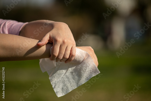 Cleaning skin and hands with antibacterial wet wipes against disease infection like flu or influenza