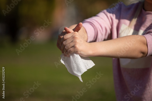 Prevention of influenza - Cleaning hands with wet wipes against disease infection like flu or influenza © Adam Radosavljevic