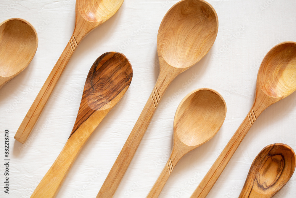 Wooden spoons made of wood on a white background. Eco-friendly dishes. Wooden spoons made of wood on a white background. Eco-friendly dishes.
