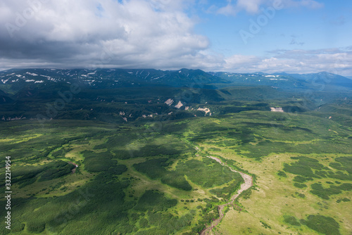 aerial view of Kamchatka volcanos, green valleys, snow and ice and the wonderful view of pure nature.