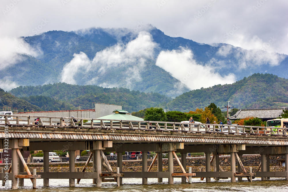 Old style wooden bridge with mountains in the background