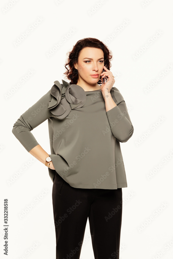 Corporate Communication. Serious businesswoman Talking On Mobile Phone isolated over white background. Corporate Communication. Serious businesswoman Talking On Mobile Phone isolated over white background.