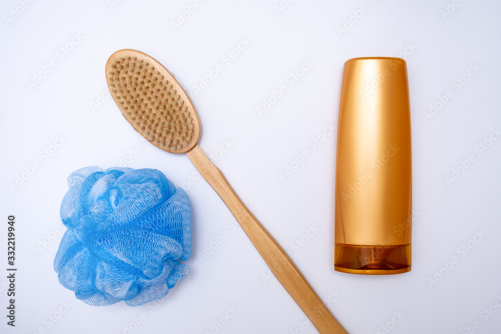 Bath, shower accessories on white background, shower gel, body wash, wooden brush and a sponge Bath, shower accessories on white background, shower gel, body wash, wooden brush and a sponge