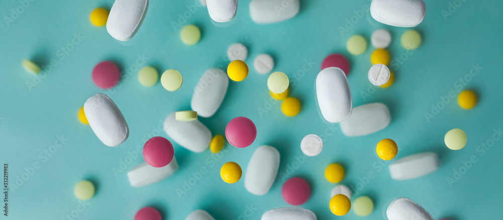 Pills for levitation. Pills on a blue background that fall down. Tablets. Medicine and health. Different types of pills, banner Pills for levitation. Pills on a blue background that fall down. Tablets. Medicine and health. Different types of pills, banner
