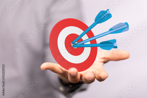 arrow hitting in the target center of dartboard on bullseye.