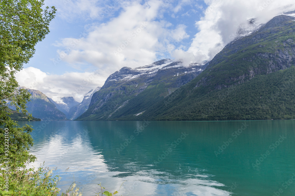 landscape of a turquoise water fjord between mountains in Norway