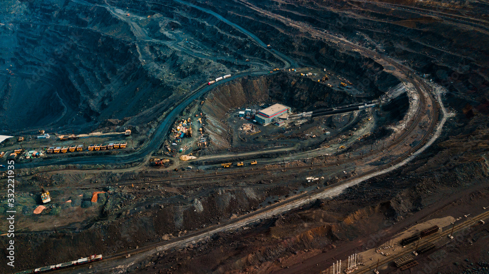 Obraz premium Aerial view of the Iron ore mining, Panorama of an open-cast mine extracting iron ore, preparing for blasting in a quarry mining iron ore, Explosive works on open pit