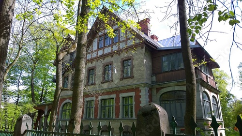 Ancient multi-storey mansion, located in the suburb of Saint Petersburg, in the city of Pushkin, Russia. Rich house. Elite real estate concept. Facade of the historical building. Early spring. photo