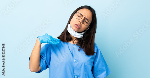 Surgeon woman over isolated blue background with tired and sick expression