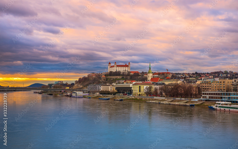 Bratislava shore with castle during twilight in cloudy weather.
