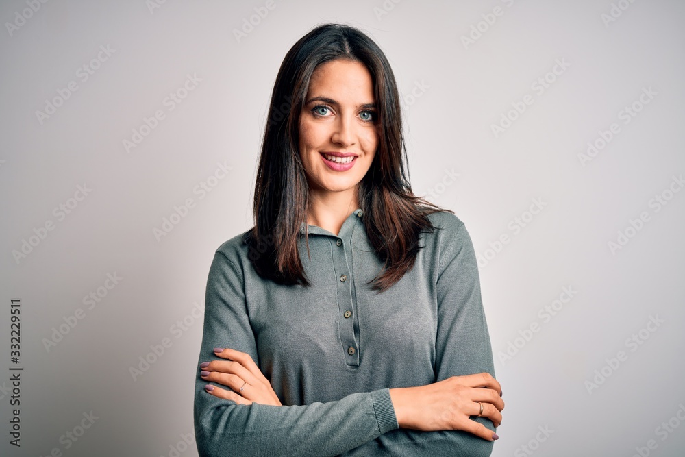 Young brunette woman with blue eyes wearing casual green sweater over white background happy face smiling with crossed arms looking at the camera. Positive person. Young brunette woman with blue eyes wearing casual green sweater over white background happy face smiling with crossed arms looking at the camera. Positive person.