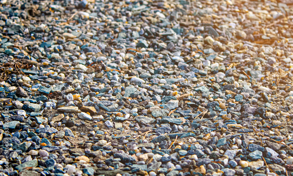 many small coastal pebbles. beach sand from stones close-up.