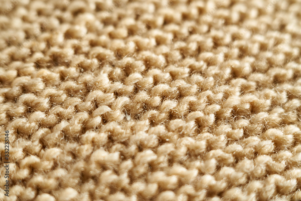 Knitted texture in beige macro with a partially blurred shawl technique