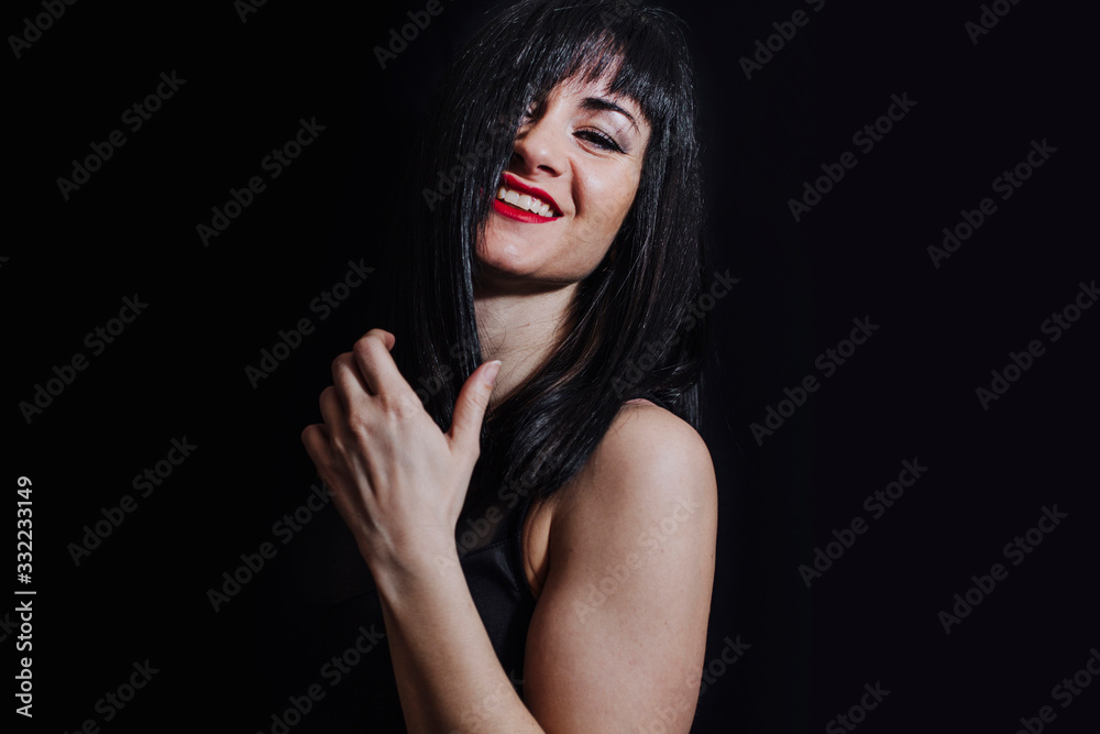 woman posing laughing on black background