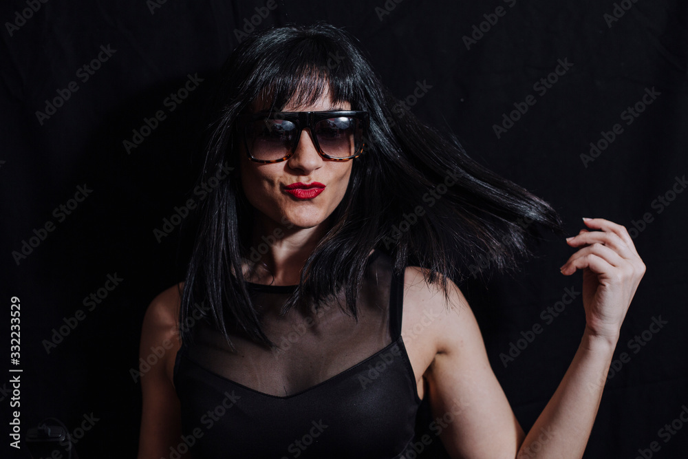 woman posing laughing with glasses on black background woman posing laughing with glasses on black background