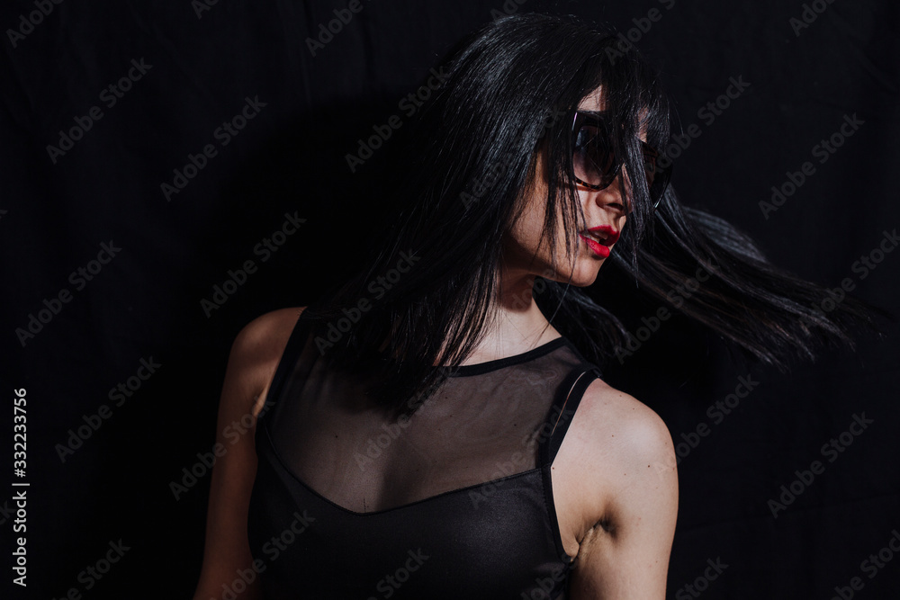 Fototapeta premium woman posing with glasses on black background