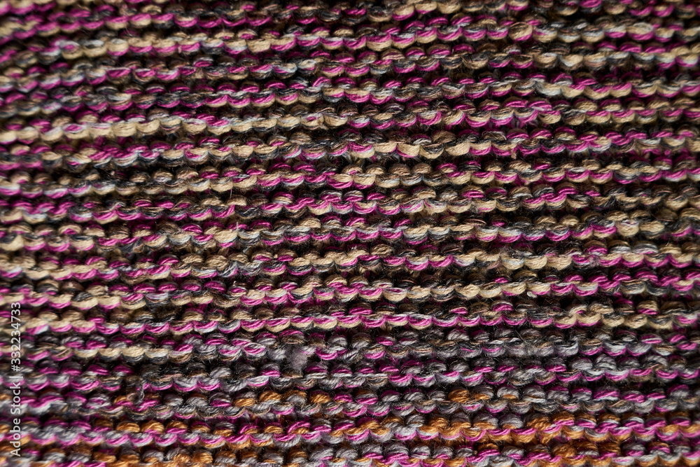 Multicolored knitted texture in macro using shawl technique Multicolored knitted texture in macro using shawl technique