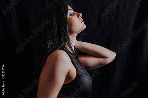woman side face posing on black background