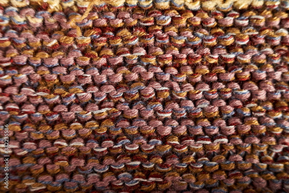 Multicolored knitted texture in macro using shawl technique Multicolored knitted texture in macro using shawl technique