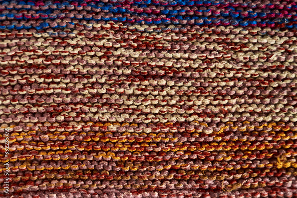 Multicolored knitted texture in macro using shawl technique Multicolored knitted texture in macro using shawl technique