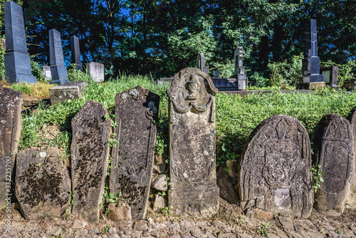 Old graves on a cemetery next to so called Church on the Hill in Sighisoara city located in Mures County, Romania photo