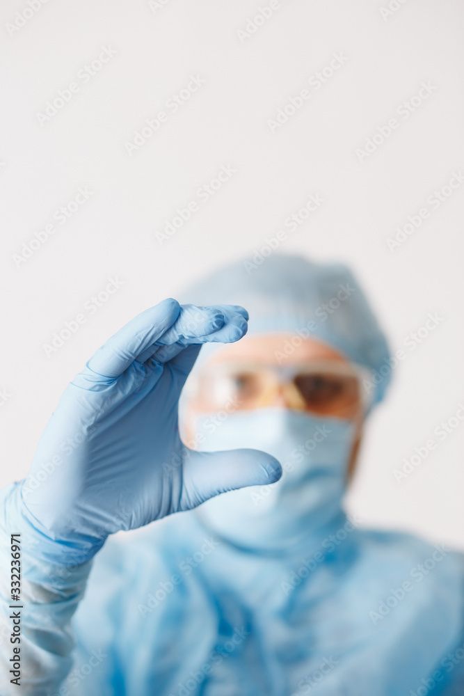 Close up of doctor hand holding. Mock up. Medical equipment. A doctor wearing personal protective equipment including mask, goggle, and suit to protect COVID-19 coronavirus infection. Close up of doctor hand holding. Mock up. Medical equipment. A doctor wearing personal protective equipment including mask, goggle, and suit to protect COVID-19 coronavirus infection.