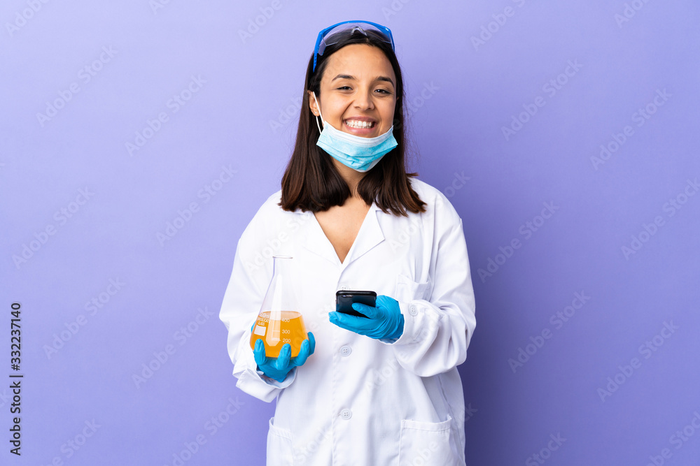 Scientist woman investigating a vaccine to cure coronavirus disease sending a message with the mobile Scientist woman investigating a vaccine to cure coronavirus disease sending a message with the mobile