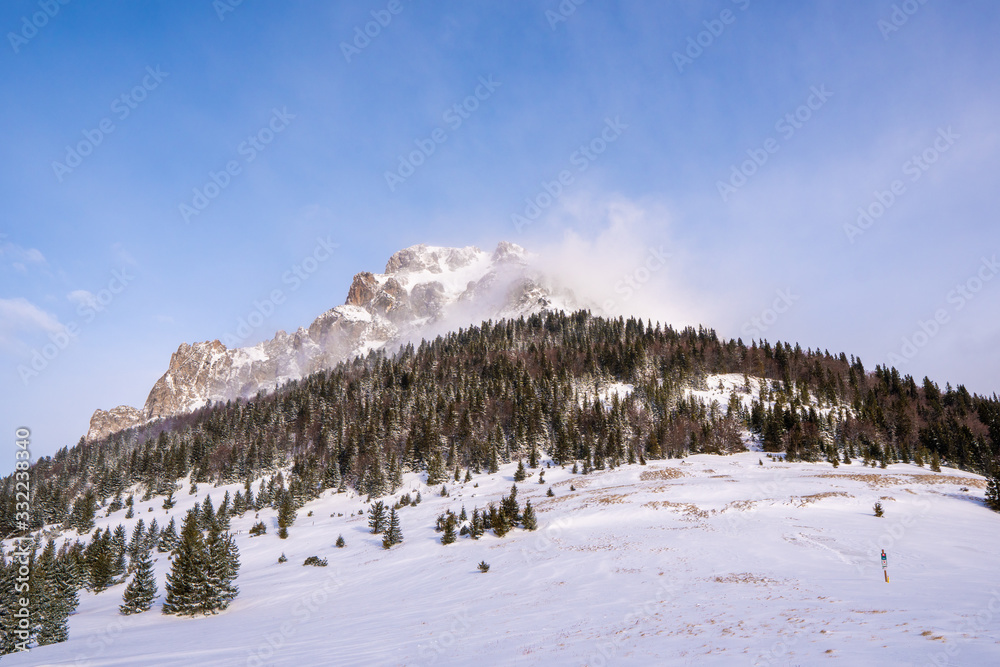 Mountain Velky Rozsutec in Male Fatra in winter and in high winds flying snow from the top, slovakia
