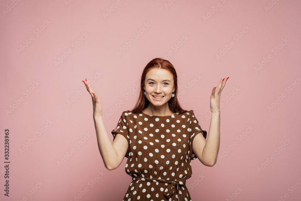 A sweet and beautiful woman experiences a strong emotion of joy and happiness. Beautiful girl on a pink background rejoices. Template for your advertisement A sweet and beautiful woman experiences a strong emotion of joy and happiness. Beautiful girl on a pink background rejoices. Template for your advertisement