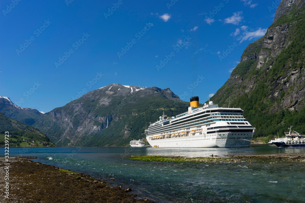 Cruise ship in Geiranger fjord in the Norwegian mountains. Cruise ship in Geiranger fjord in the Norwegian mountains.