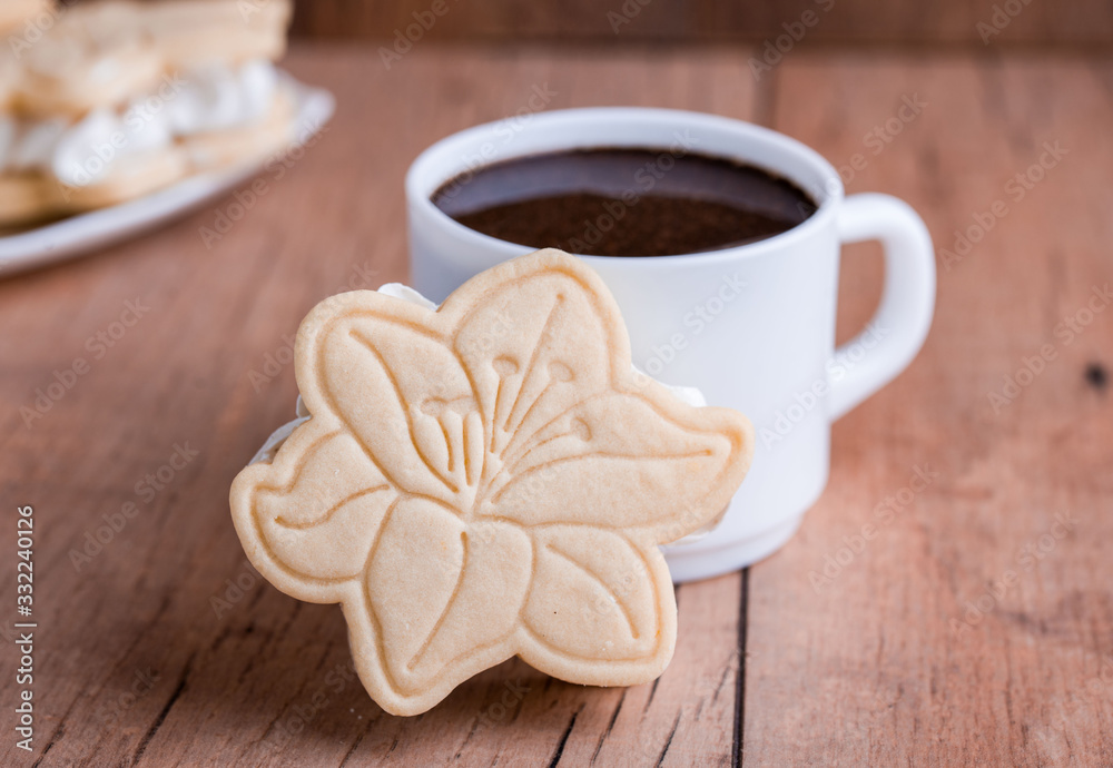 Shortbread cookies with meringue in the form of a flower, on a light wood background. Shortbread cookies with meringue in the form of a flower, on a light wood background.