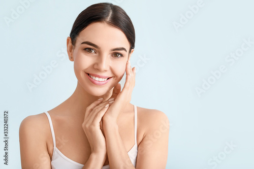 Obraz na plátně Beautiful young woman with healthy skin on color background