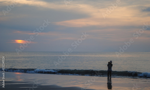 The couple enjoy a romantic sunset on the beach Series #1