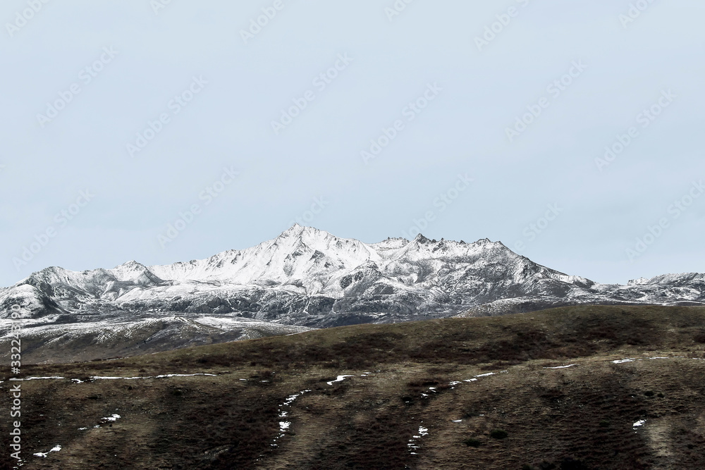 Fototapeta premium winter landscape of snow mountain with grassland
