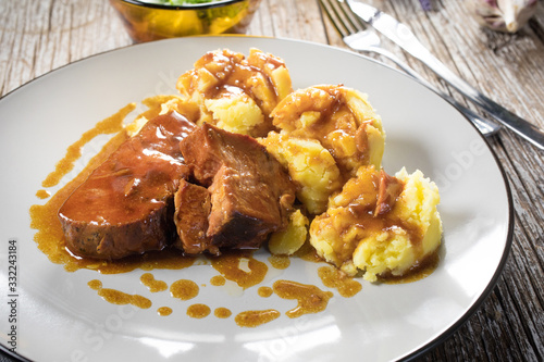 Braised pork neck in own sauce served with boiled potatoes.