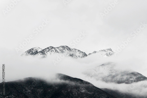 winter landscape of snow mountain peak in fog 