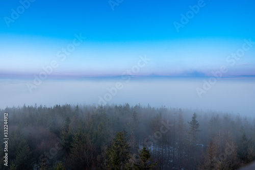 beautiful fog in mountains before sunrise with forest with moon  Czech Beskydy